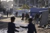 FILE - Displaced Palestinians carry water in Jabaliya, Gaza Strip on Monday, March 31, 2025. (AP Photo/Jehad Alshrafi, File)