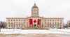 A giant Canadian flag is installed Tuesday morning on the front of the Manitoba legislative building, hours after U.S. President Donald Trump's tariffs on Canadian products came into effect. In response to the tariffs, Manitoba Premier Wab Kinew announced U.S. alcohol will be pulled from the shelves of provincially run liquor stores and said there are tax deferrals in motion for Manitoba businesses affected by the tariffs. (Mike Deal / Free Press)
