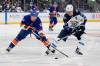 Frank Franklin II / The Associated Press
                                Casey Cizikas (left) of the Islanders and the Jets&rsquo; Mark Scheifele battle for the puck Tuesday night in Elmont, N.Y.