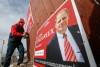 JOHN WOODS / FREE PRESS
                                Liberal candidate Kevin Lamoureux, hangs signs on a house fence on Selkirk at Keewatin Sunday, March 23, 2025. It is expected that a federal election will be called today. Reporter: marsha