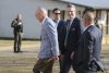 Secretary of Defense Pete Hegseth, center, walks with Scott Burns, left, as they enter 