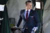 Wearing a U.S. flag themed pocket square and belt buckle, Defense Secretary Pete Hegseth waits for the start of a television interview outside the White House, Friday, March 21, 2025, in Washington. (AP Photo/Jacquelyn Martin)