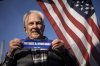 Brian Calder holds a bumper sticker he designed in support of Canada in Point Roberts, Wash., Wednesday, March 5, 2025. THE CANADIAN PRESS/Ethan Cairns