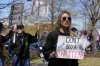 Abby Wigger protests against Elon Musk and President Donald Trump outside a Tesla dealership Saturday, March 22, 2025, in Franklin, Tenn. (AP Photo/George Walker IV)