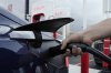 FILE - A motorist charges his electric vehicle at a Tesla Supercharger station in Detroit, Nov. 16, 2022. (AP Photo/Paul Sancya, File)