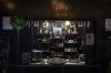 Bottles and decorations are seen in the tasting area of The Bard Distillery in Graham, Ky., Sunday, March 9, 2025. (AP Photo/Jon Cherry)