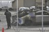 A person inspects a burned Cybertruck in a Tesla lot in Seattle, Monday, March 10, 2025. (AP Photo/Manuel Valdes)