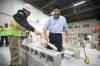 Federal NDP leader Jagmeet Singh learns to lay bricks with the help of student Greg Wood during tour of the training facility at Manitoba Building Trades Institute after Singh&rsquo;s news conference Wednesday.
