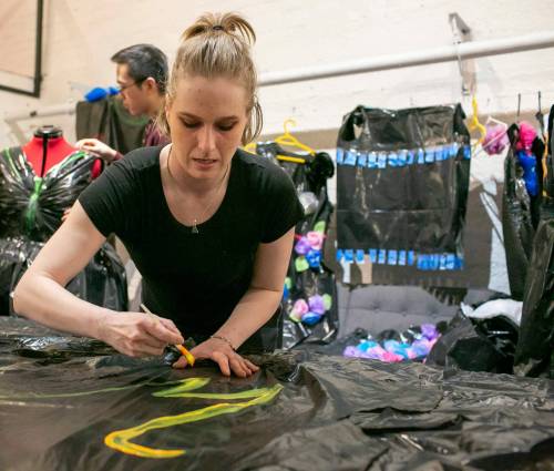 BROOK JONES/FREE PRESS
                                Voices alumni and dress designer Brittany-Morgan Erb paints a garbage bag dress for the Voices: Manitoba&rsquo;s Youth in Care Network fundraiser.