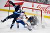 Edmonton Oilers&rsquo; Max Jones (46) collides with Winnipeg Jets&rsquo; Colin Miller (6) in front of goaltender Eric Comrie (1) during third period NHL action in Winnipeg, Sunday April 13 2025. THE CANADIAN PRESS/Fred Greenslade