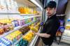 MIKE DEAL / FREE PRESS Brayden Halayko, store supervisor of Downtown Family Foods, 120 Donald St. Downtown Family Foods has noticed an increased cost on its U.S. imports, like orange juice and canned soups. As such, it’s been bringing on more Canadian products. Reporter: Dean Pritchard 250416 - Wednesday, April 16, 2025.