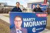 BROOK JONES / FREE PRESS
                                Incumbent Conservative candidate Marty Morantz (left) holds a large re-elect campaign sign with his campaign manager Michael Kowalson while the duo are pictured alongside Portage Avenue in Winnipeg, Man., Thursday, April 17, 2025. Morantz, who is a two-term Conservative incumbent, is running in the federal riding of Winnipeg West.