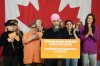 NDP Leader Jagmeet Singh stands with health-care workers and NDP candidate for Toronto-Danforth Clare Hacksel (right) as he makes an announcement during a federal election campaign event in Toronto on Monday, April 14, 2025. THE CANADIAN PRESS/Chris Young