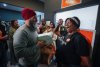 NDP Leader Jagmeet Singh speaks with a supporter while delivering baked goods and chocolates to volunteers at the London Centre and London West NDP campaign office, in Windsor, Ont., Saturday, April 26, 2025. THE CANADIAN PRESS/Darryl Dyck