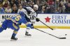 St. Louis Blues defenseman Tyler Tucker, left, blocks a shot from Winnipeg Jets center Adam Lowry during the first period of an NHL hockey game, Saturday, Feb. 22, 2025, in St. Louis. (AP Photo/Jeff Le)