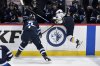 St. Louis Blues' Nathan Walker (26) is checked by Winnipeg Jets' Luke Schenn (5) during first period NHL round one, game seven Stanley Cup playoff action in Winnipeg, Sunday, May 4, 2025. THE CANADIAN PRESS/Fred Greenslade