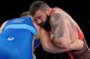 FILE - Georgia's Iakobi Kajaia, right, and Russian Olympic Committee's Sergei Semenov grapple during a men's 130kg Greco-Roman wrestling match at the 2020 Summer Olympics, Sunday, Aug. 1, 2021, in Chiba, Japan. (AP Photo/Aaron Favila, File)