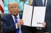 President Donald Trump holds a proclamation on National Hurricane Preparedness week in the Oval Office of the White House, Monday, May 5, 2025, in Washington. (AP Photo/Alex Brandon)