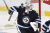 Winnipeg Jets goaltender Connor Hellebuyck (37) makes a save on a St. Louis Blues shot during third period NHL playoff action in Winnipeg, Monday April 21, 2025. THE CANADIAN PRESS/Fred Greenslade