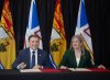 Andrew Furey, premier of Newfoundland and Labrador, and Susan Holt, premier of New Brunswick, sign a memorandum of understanding between the two provinces on Thursday, April 24, 2025, in the lobby of the Confederation Building in St. John's, N.L. THE CANADIAN PRESS/Paul Daly