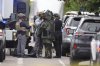 Law enforcement officials dress to investigate after an attack on the Peark Street Mall Sunday, June 1, 2025, in Boulder, Colo. (AP Photo/David Zalubowski)