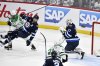 Winnipeg Jets goaltender Connor Hellebuyck (37) makes a save as Dallas Stars' Mason Marchment (27) dumps Josh Morrissey (44) during first period NHL playoff hockey action in Winnipeg, Friday May 9, 2025. THE CANADIAN PRESS/Fred Greenslade