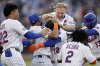 New York Mets' Francisco Lindor (12) is congratulated by teammates after hitting a walkoff sacrifice fly during the ninth inning of a baseball game against the Chicago White Sox, Monday, May 26, 2025, in New York. (AP Photo/Adam Hunger)