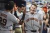 San Francisco Giants' Matt Chapman, right, reacts after hitting a solo home run during the fourth inning of a baseball game against the Miami Marlins, Friday, May 30, 2025, in Miami. (AP Photo/Lynne Sladky)