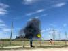 ERIK PINDERA / FREE PRESS Passersby at the end of Wabasha Street watch plumes of smoke from a massive fire in north Transcona on Monday afternoon.