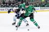 Winnipeg Jets defenseman Neal Pionk (4) and Dallas Stars center Roope Hintz (24) compete for control of the puck in the first period of Saturday&rsquo;s game. The Stars won 2-1 in overtime. (Gareth Patterson / The Associated Press)