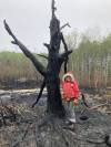 (Submitted)
                                JoAnneHirst next to a charred tree on a piece of property she rents out along Wendigo Road.