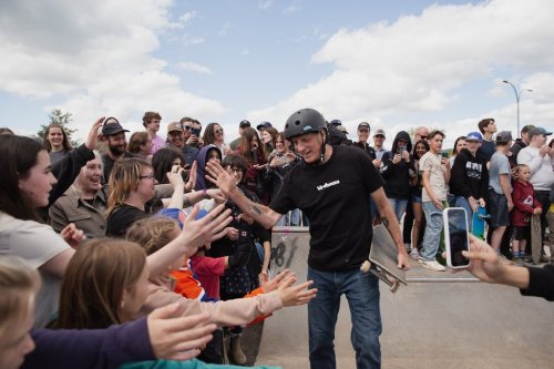 Skateboarding legend Tony Hawk high-fives young fans during the grand opening of the expanded Smithers Skate Park in Smithers, B.C., in this Thursday, May 29, 2025 handout photo. Hawk and Canadian snowboarder Mark McMorris visited the northern B.C. town of 5,000 to celebrate the community’s $1.8-million effort to grow the park. THE CANADIAN PRESS/HO, Erica Chan *MANDATORY CREDIT*