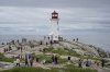 Hundreds of people walk near the lighthouse in Peggy's Cove, N.S., Tuesday, July 4, 2023. THE CANADIAN PRESS/Darren Calabrese