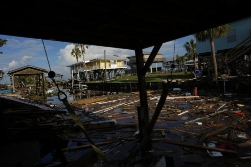 FILE - Debris from destroyed homes and structures floats in a canal in Horseshoe Beach, Fla., Aug. 31, 2023, one day after the passage of Hurricane Idalia. (AP Photo/Rebecca Blackwell, File)