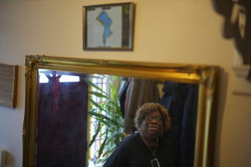 Chagossian Bernadette Dugasse looks at a Chagos Islands map during an interview with The Associated Press, at her home in London, Tuesday, March 25, 2025. (AP Photo/Kin Cheung)