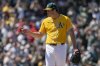 Athletics pitcher Mason Miller points to catcher Willie MacIver after winning a baseball game against the Philadelphia Phillies, Sunday, May 25, 2025, in West Sacramento, Calif. (AP Photo/Sara Nevis)