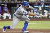 Los Angeles Dodgers Chris Taylor lays down a bunt against the Arizona Diamondbacks during the third inning of a baseball game, Friday, May 9, 2025, in Phoenix. (AP Photo/Darryl Webb)