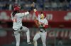 Cincinnati Reds' Elly De La Cruz (44) and TJ Friedl, celebrate after their baseball game against the Kansas City Royals, Tuesday, May 27, 2025, in Kansas City, Mo. (AP Photo/Charlie Riedel)