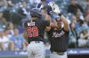 Washington Nationals' James Wood high fives Nathaniel Lowe after hitting a solo home run during the fifth inning of a baseball game against the Seattle Mariners Wednesday, May 28, 2025, in Seattle. (AP Photo/Ryan Sun)