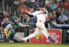 Houston Astros' Victor Caratini (17) hits a two-run single against Athletics relief pitcher Justin Sterner during the seventh inning of a baseball game, Wednesday, May 28, 2025, in Houston. (AP Photo/Karen Warren)