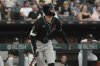 Arizona Diamondbacks' Pavin Smith watches his solo home run during the fourth inning of a baseball game against the Chicago White Sox in Chicago, Monday, June 23, 2025. (AP Photo/Nam Y. Huh)
