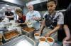 JOHN WOODS / FREE PRESS
                                Volunteers from St Vital parish and school Ulysse Poirier, from left, Sally Bader, Bob, and Angela Daet, teacher at St Vital School, prepare a meal for fire evacuees who are being housed at Century Arena in Winnipeg Sunday, June 1, 2025. Reporter: nicole