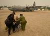 David Lipnowski / THE CANADIAN PRESS
                                Members of the Royal Canadian Air Force help evacuate Abbie Duskun (seated) and her daughter Veronica Clarke as they board a C-130 Hercules aircraft in Norway House June 5, at the Norway House Airport as crews continue to fight wildfires in northern Manitoba.