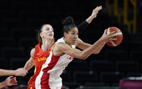 Canada's Miranda Ayim (9), right, passes the ball ahead of Spain's Laura Gil (24), left, during women's basketball preliminary round game at the 2020 Summer Olympics, Sunday, Aug. 1, 2021, in Saitama, Japan. (AP Photo/Charlie Neibergall)