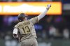 San Diego Padres' Manny Machado gestures as he rounds the bases after hitting a solo home run during the seventh inning of a baseball game against the Milwaukee Brewers, Sunday, June 8, 2025, in Milwaukee. (AP Photo/Aaron Gash)