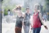 Canada is expected to see a warmer than usual summer with uncertain precipitation levels in most provinces, according to Environment and Climate Change Canada's 2025 summer outlook. People use misters to cool down in Montreal, Monday, July 2, 2018, during a heatwave in the city. THE CANADIAN PRESS/Graham Hughes
