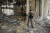 Israeli border police officers walk at the entrance of a residential building hit by a missile launched from Iran, in Petah Tikva, Israel, Monday, June 16, 2025. (AP Photo/Baz Ratner)
