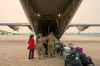 Members of the Royal Canadian Air Force help evacuees board a C-130 Hercules aircraft in Norway House, Man., Tuesday, June 3, 2025, at the Norway House Airport as crews continue to fight wildfires in northern Manitoba. THE CANADIAN PRESS/David Lipnowski