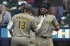 San Diego Padres' Manny Machado (13) is congratulated by Fernando Tatis Jr. after hitting a solo home run during the seventh inning of a baseball game against the Milwaukee Brewers, Sunday, June 8, 2025, in Milwaukee. (AP Photo/Aaron Gash)