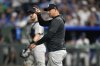 New York Yankees manager Aaron Boone signals for a pitching change in the eighth inning during a baseball game against the Kansas City Royals, Wednesday, June 11, 2025, in Kansas City, Mo. (AP Photo/Ed Zurga)